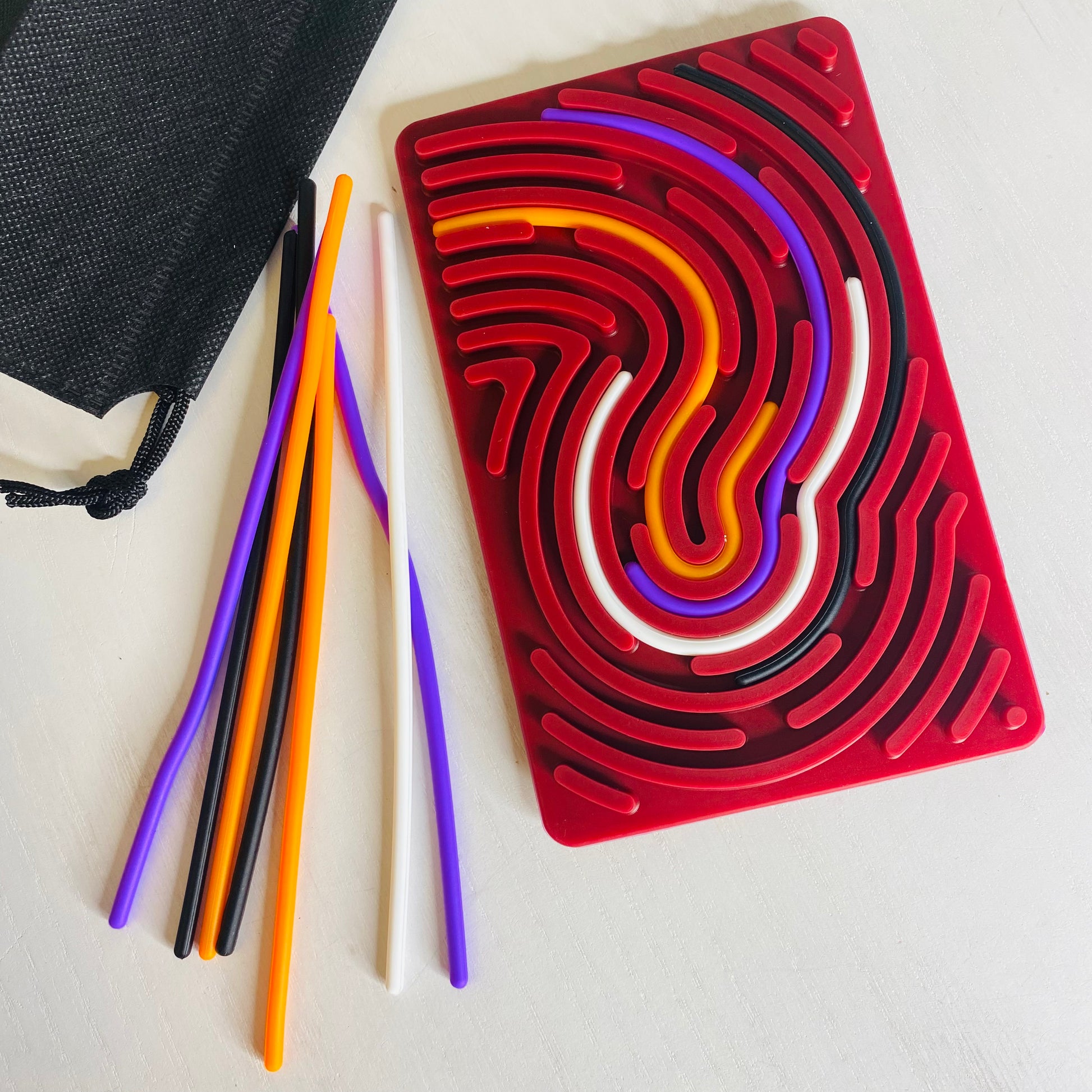 Great sensory toy for kids. Calming activity with a silicone board with grooves in it. They calmly smooth silicone sticks into the grooves getting a nice sensory experience while calming.