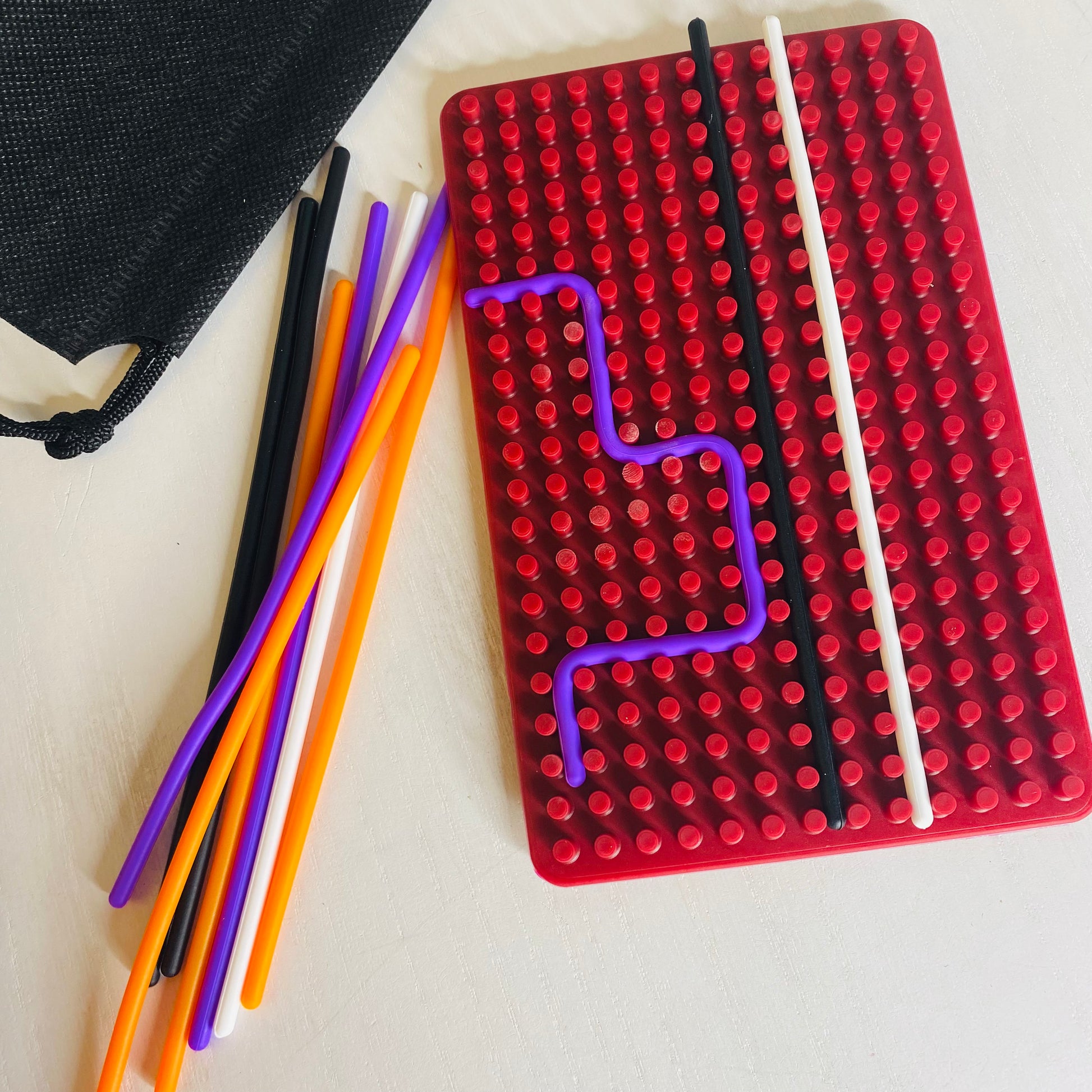 Great sensory toy for kids. Calming activity with a silicone board with grooves in it. They calmly smooth silicone sticks into the grooves getting a nice sensory experience while calming.