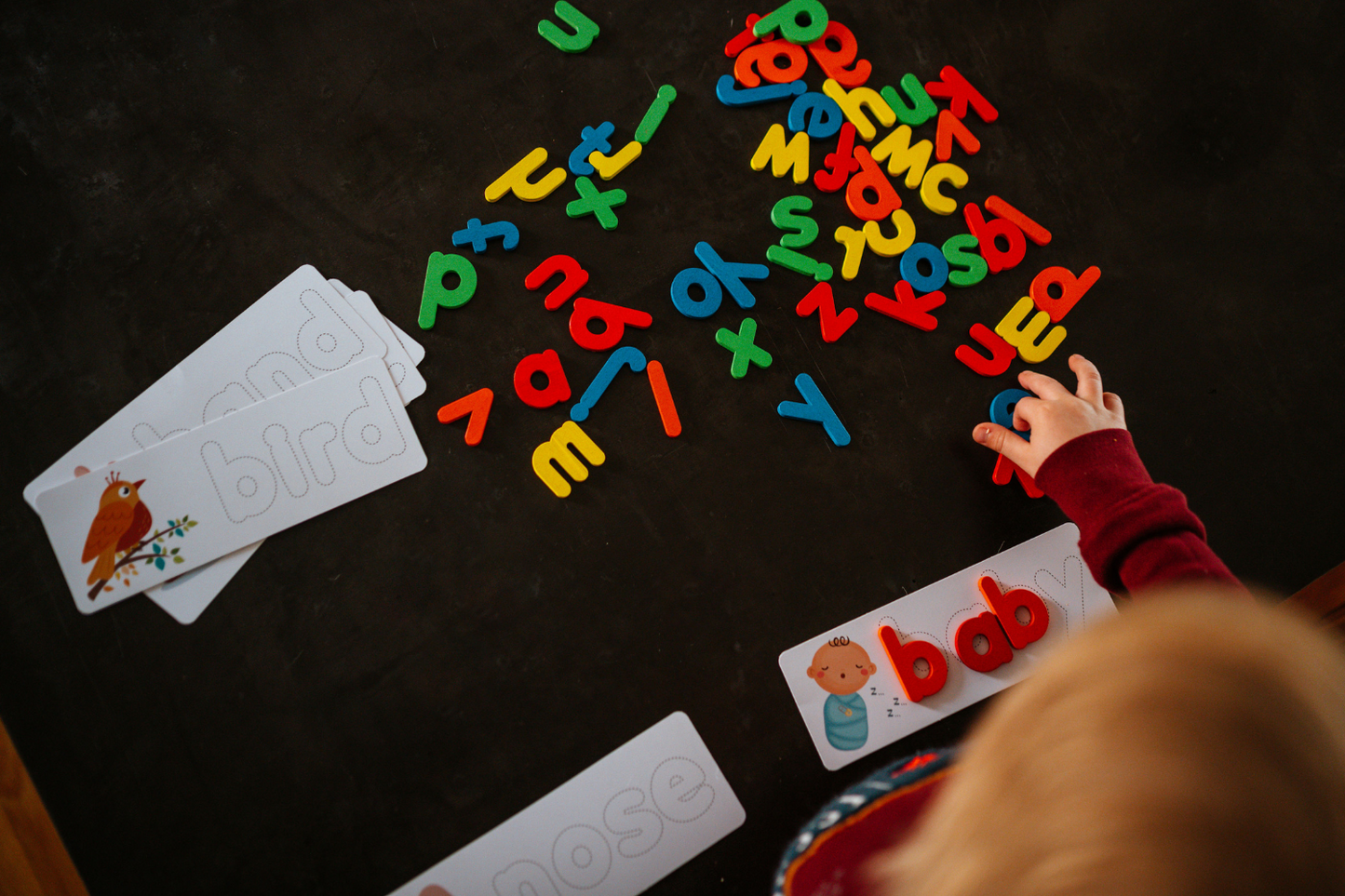 develop fine motor skills when matching up our wooden letters to the word cards Fun Learn Grow Co.