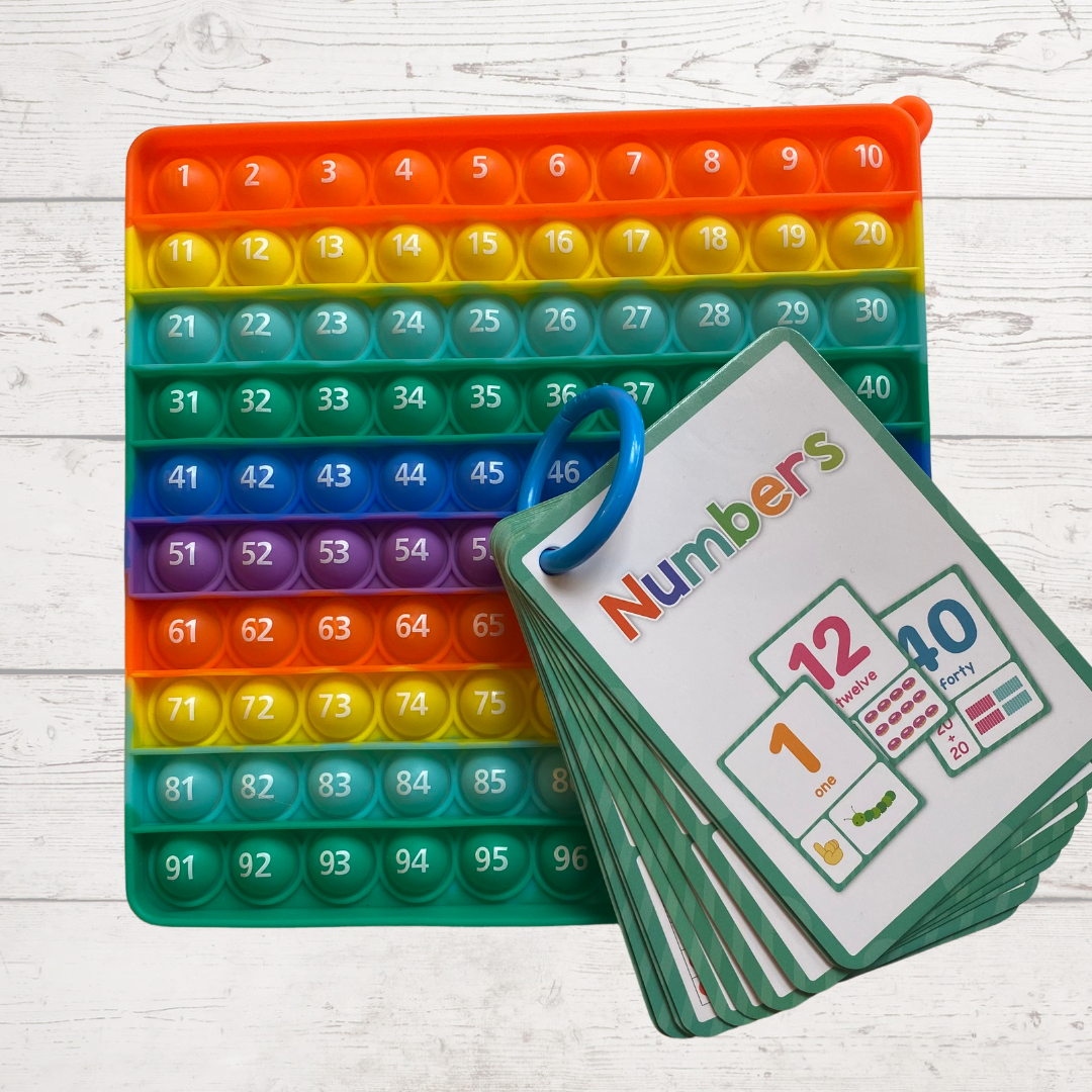 Square number learning pop it toy with numbers 1-100 on one side and 101-200 on the other side. It is rainbow in color with orange, yellow, green, blue and purple.  Fun Learn Grow Co.