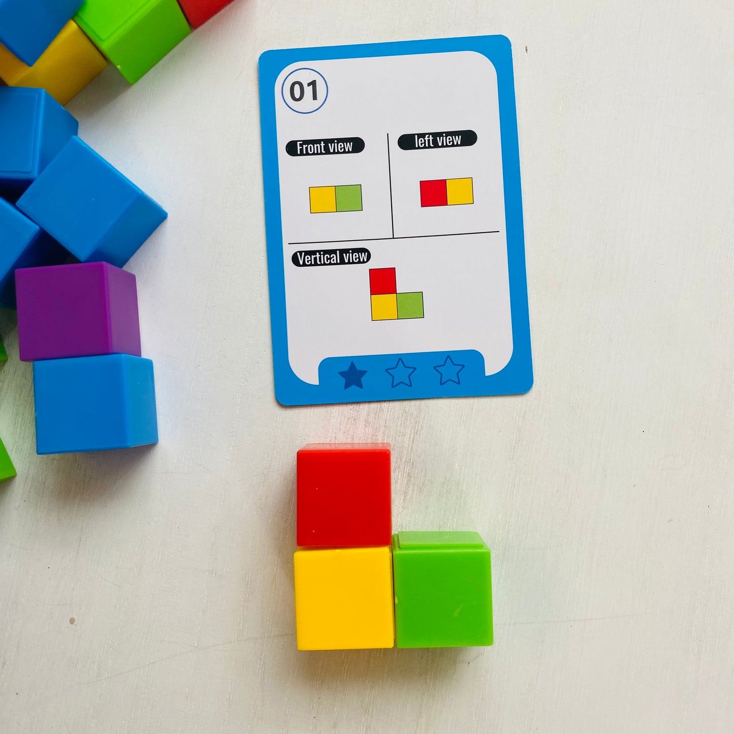 Logic puzzle with colored blocks and 27 double-sided challenge cards. Kids stack the blocks to match the cards. Fun Learn Grow Co.