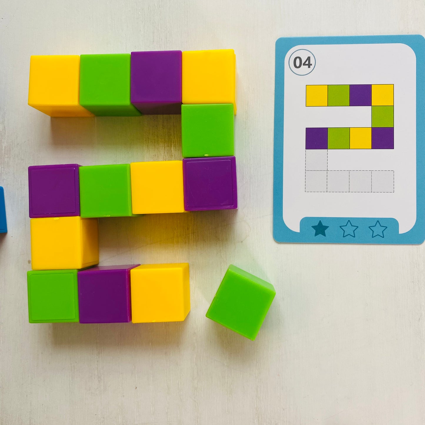 Logic puzzle with colored blocks and 27 double-sided challenge cards. Kids stack the blocks to match the cards. Fun Learn Grow Co.