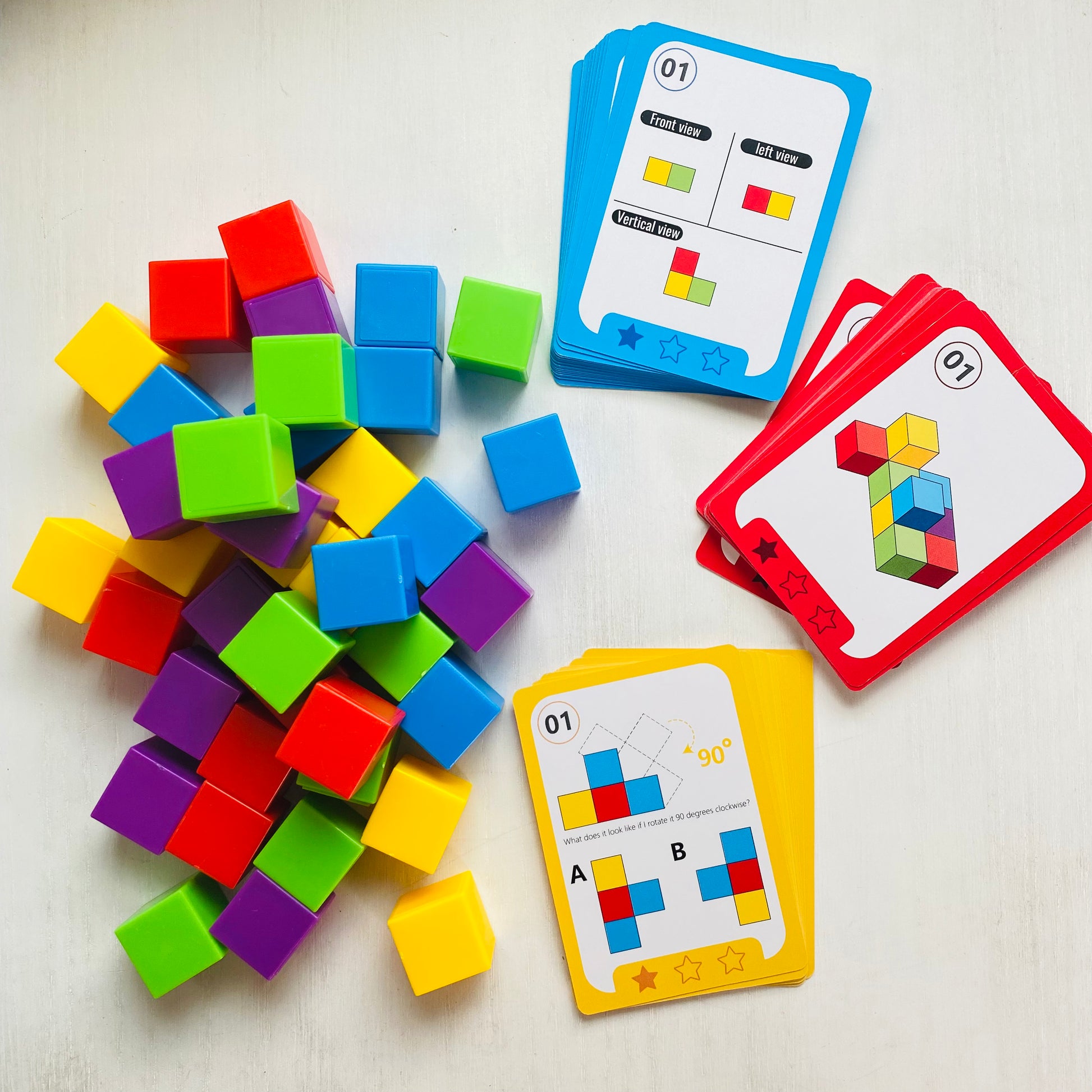 Logic puzzle with colored blocks and 27 double-sided challenge cards. Kids stack the blocks to match the cards.