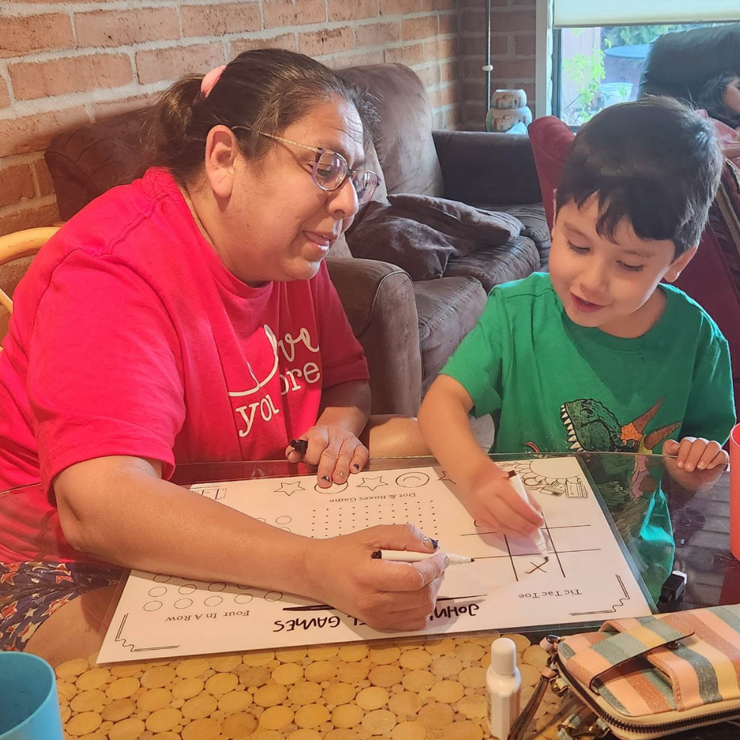 Grammy and grandson bonding with kids travel games placemat! Fun Learn Grow Co.